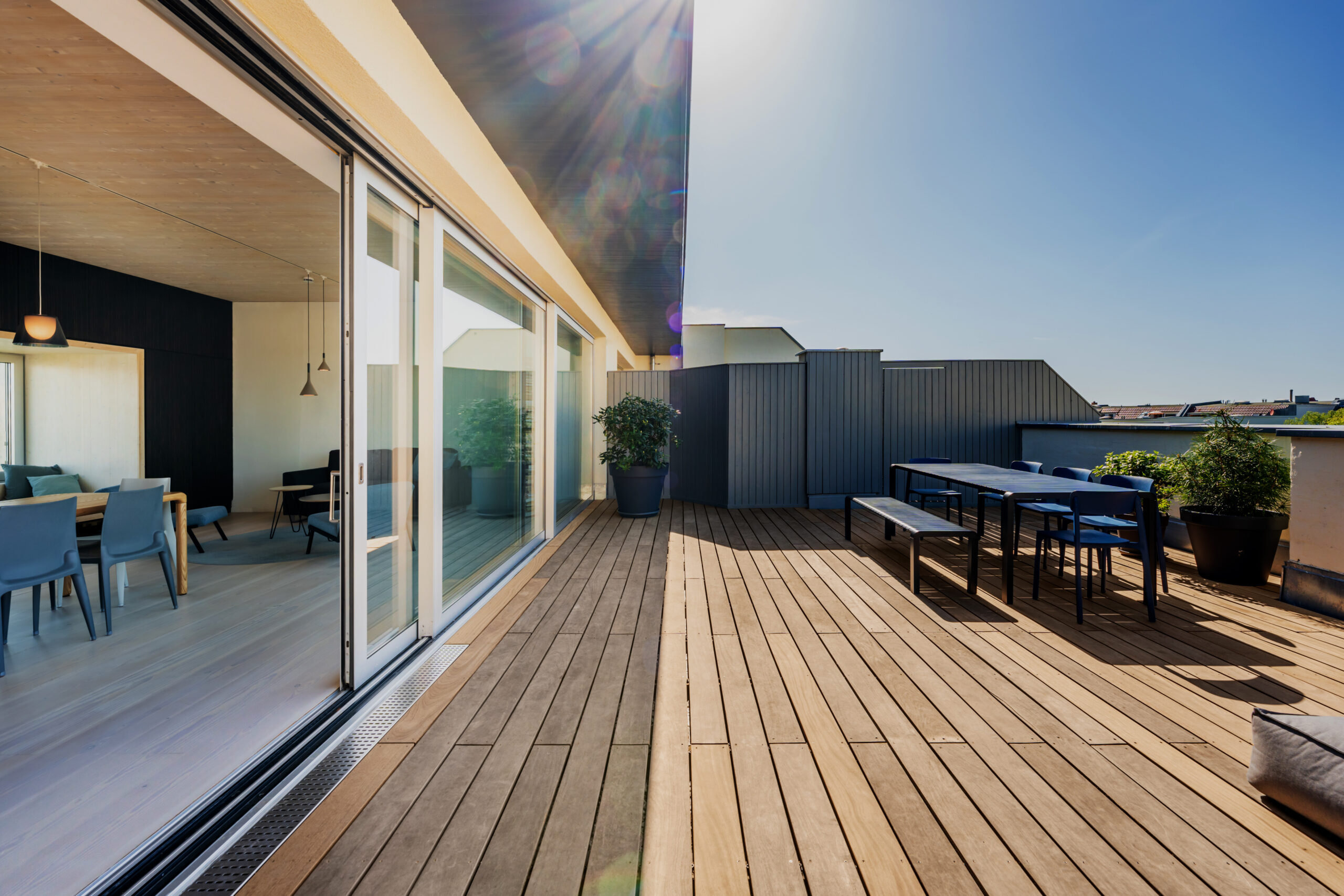 Luxury Rooftop Deck Patio Hardwood rooftop patio deck with a picknick table and chairs. Floor to ceiling sliding doors open up to the loft apartment.